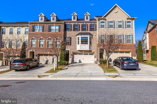 view of property with brick siding, driveway, and an attached garage