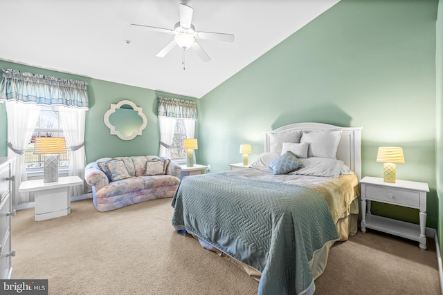 carpeted bedroom with vaulted ceiling and ceiling fan