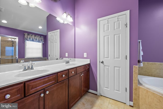 full bath featuring a garden tub, double vanity, tile patterned flooring, and a sink