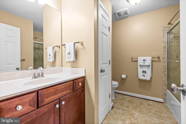 full bath featuring enclosed tub / shower combo, tile patterned flooring, toilet, vanity, and baseboards