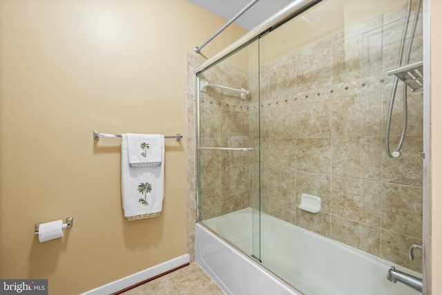 bathroom with combined bath / shower with glass door, baseboards, and tile patterned floors