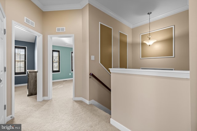 hall with crown molding, an upstairs landing, visible vents, and light colored carpet