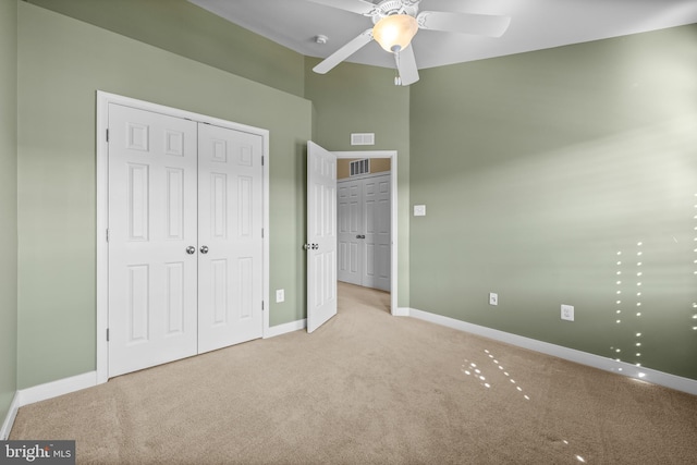 unfurnished bedroom with baseboards, visible vents, and light colored carpet