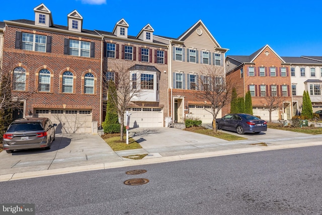 multi unit property featuring driveway, an attached garage, and brick siding