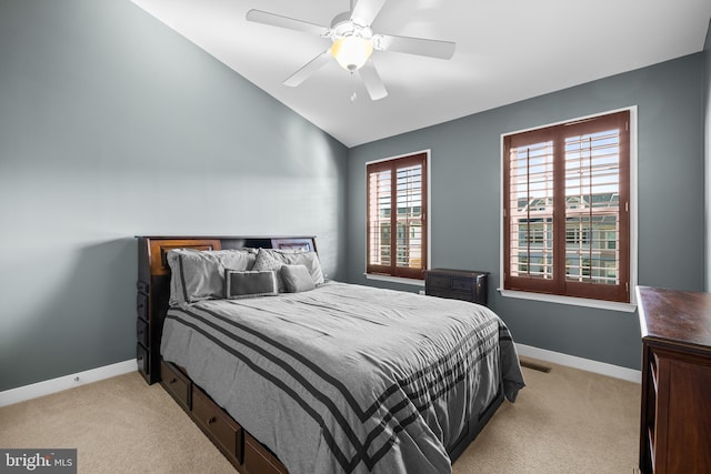 bedroom with light carpet, lofted ceiling, and baseboards