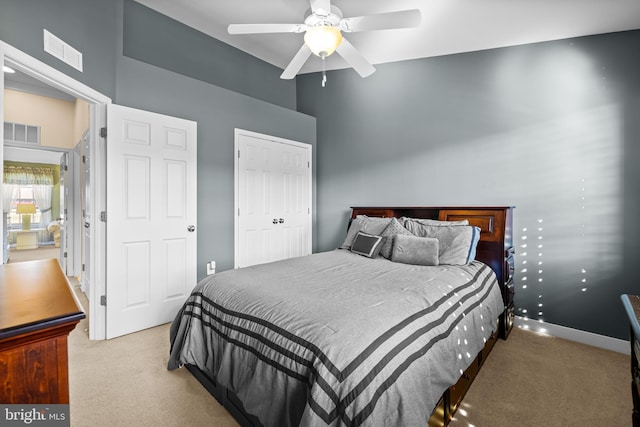 bedroom with carpet floors, visible vents, and a closet