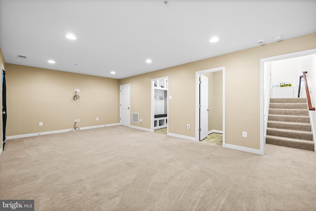 interior space featuring light carpet, recessed lighting, visible vents, and stairway