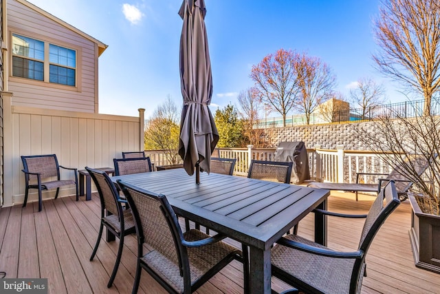 wooden deck featuring outdoor dining area