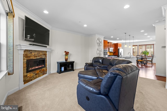 living room with ornamental molding, recessed lighting, visible vents, and a fireplace