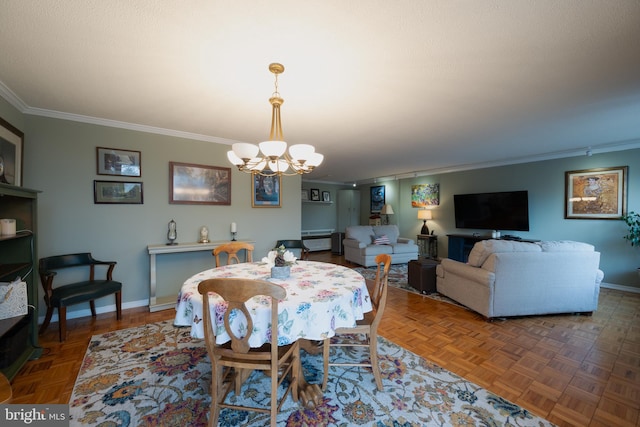 dining space with parquet flooring, ornamental molding, and a chandelier