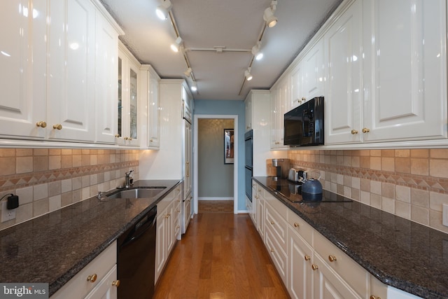 kitchen featuring sink, white cabinets, and black appliances