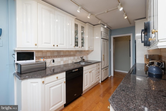 kitchen featuring tasteful backsplash, white cabinetry, sink, black appliances, and light hardwood / wood-style flooring