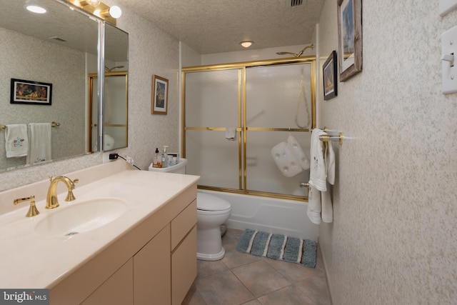 full bathroom with toilet, a textured ceiling, vanity, enclosed tub / shower combo, and tile patterned flooring