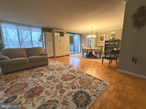 living room featuring parquet flooring and a chandelier