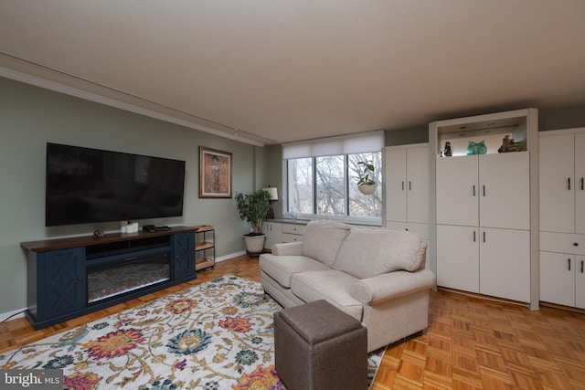 living room with crown molding and light parquet floors