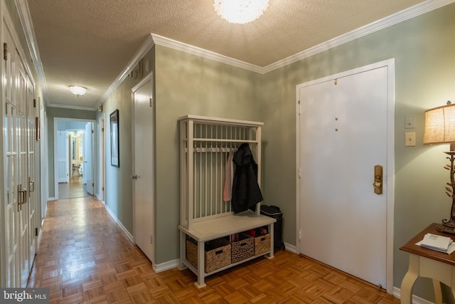 mudroom featuring light parquet floors, crown molding, and a textured ceiling