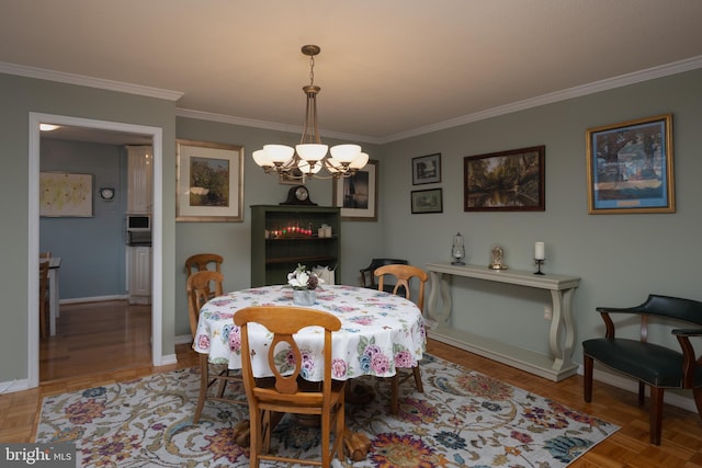 dining area with crown molding, parquet floors, and a chandelier