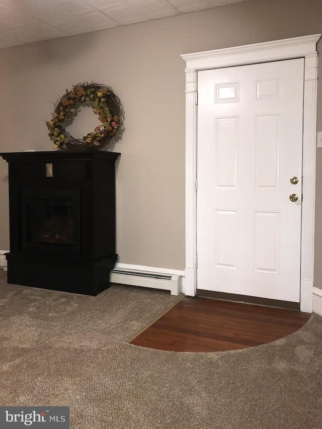 entryway with a baseboard radiator and a paneled ceiling