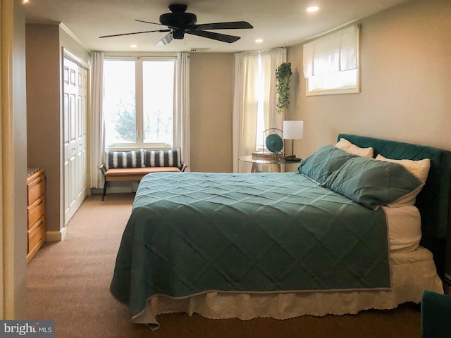 bedroom featuring light carpet and ceiling fan