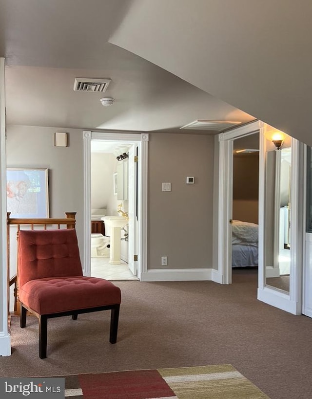 sitting room featuring carpet flooring