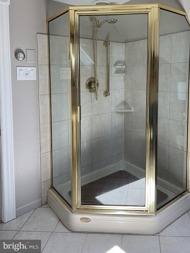 bathroom featuring tile patterned floors and a shower with shower door