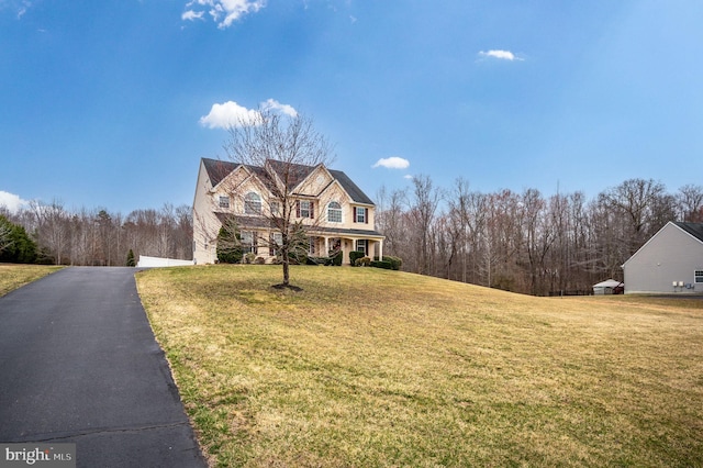 view of front of home with a front yard and a garage