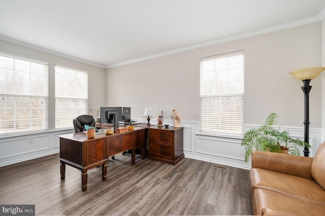 office space with a healthy amount of sunlight, wood finished floors, and crown molding