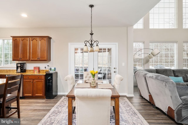 dining room with an inviting chandelier, recessed lighting, wood finished floors, and baseboards