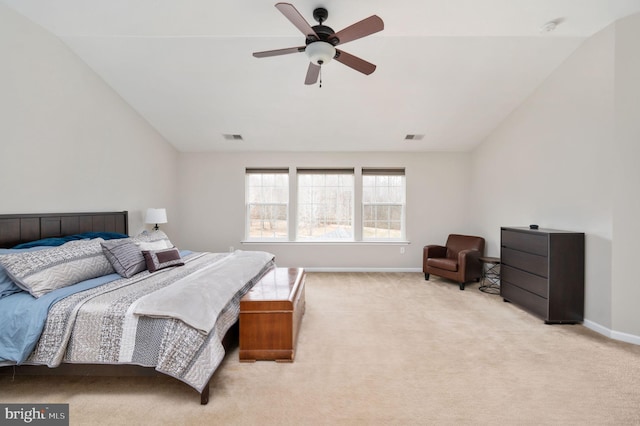 bedroom with lofted ceiling, light colored carpet, visible vents, and baseboards