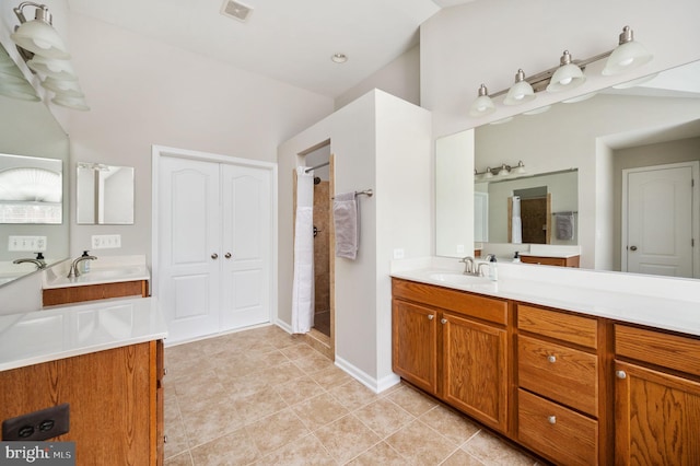 full bathroom featuring vanity, tile patterned floors, visible vents, and tiled shower