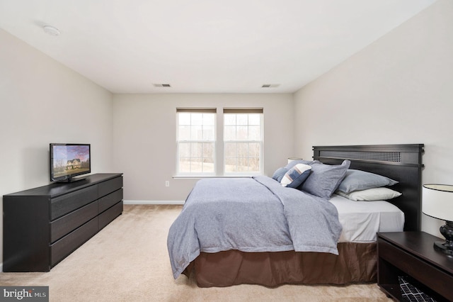 bedroom featuring light colored carpet, visible vents, and baseboards