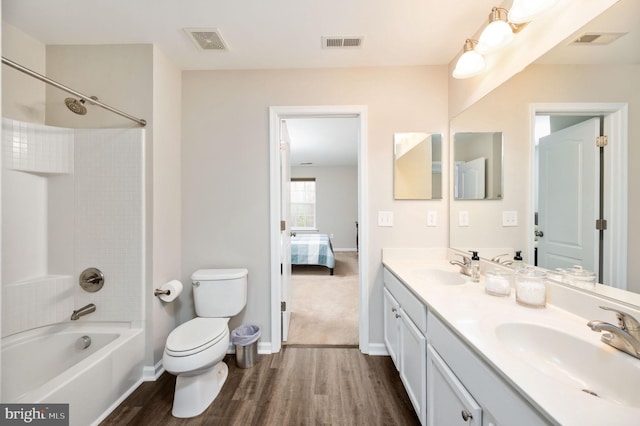 full bathroom featuring visible vents, wood finished floors, and a sink