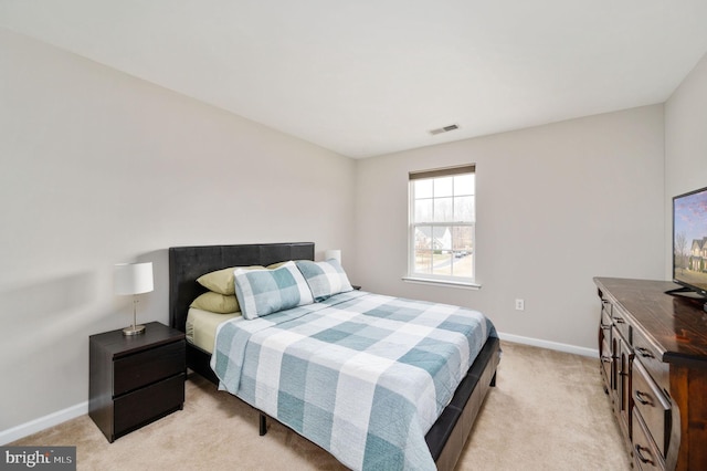 bedroom featuring light colored carpet, visible vents, and baseboards