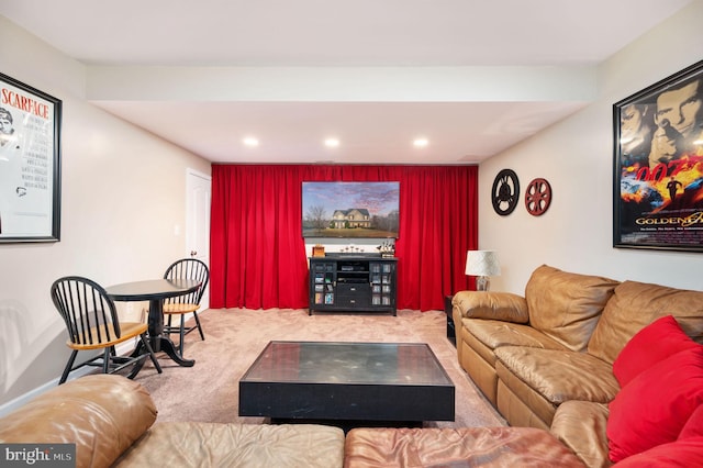 living area with an accent wall, recessed lighting, and carpet floors