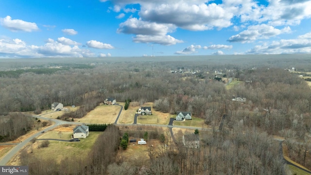 birds eye view of property with a rural view and a wooded view