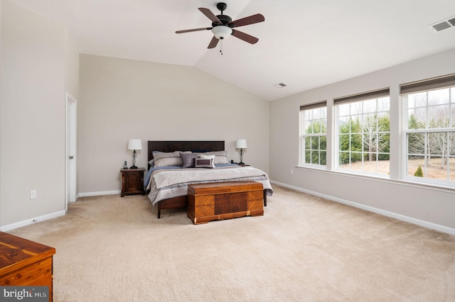 bedroom with a ceiling fan, baseboards, visible vents, vaulted ceiling, and light carpet