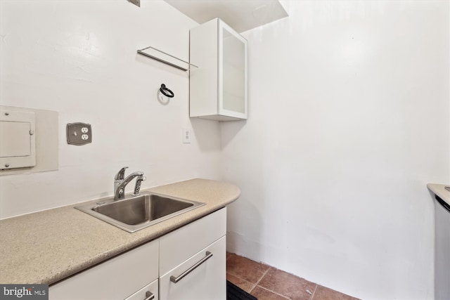 kitchen featuring sink and white cabinets