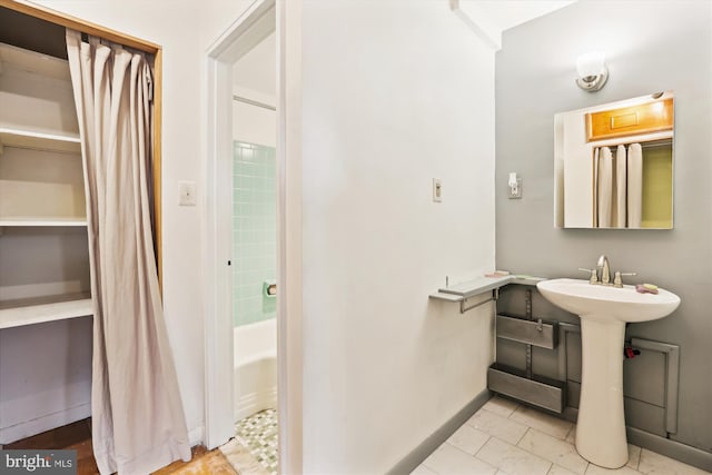 bathroom with shower / tub combo and sink