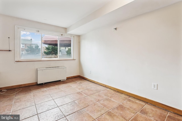 tiled spare room with radiator