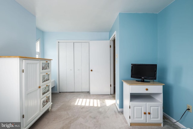 interior space featuring light carpet and a closet