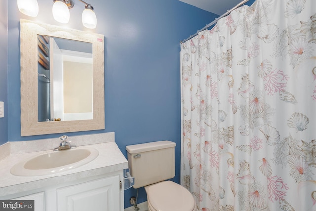 bathroom featuring vanity, a shower with shower curtain, and toilet