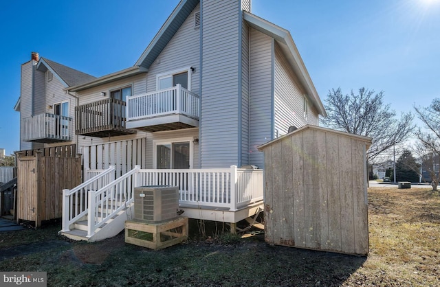 back of house with central AC and a balcony