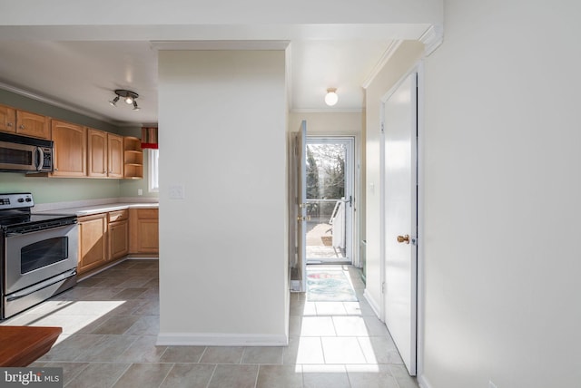 kitchen featuring stainless steel appliances and ornamental molding