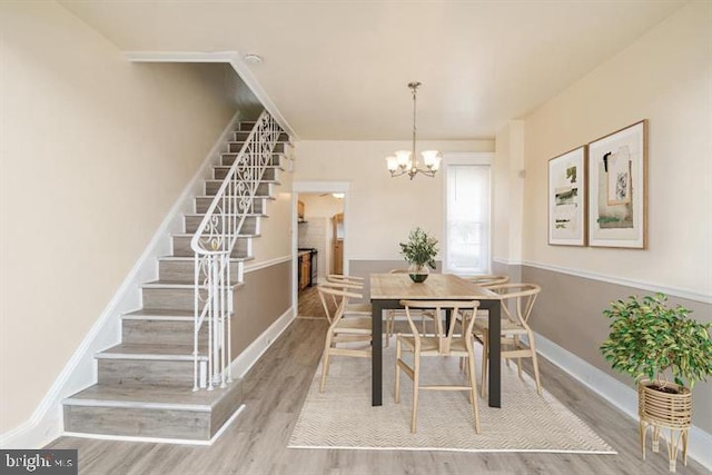 dining area featuring an inviting chandelier and wood-type flooring