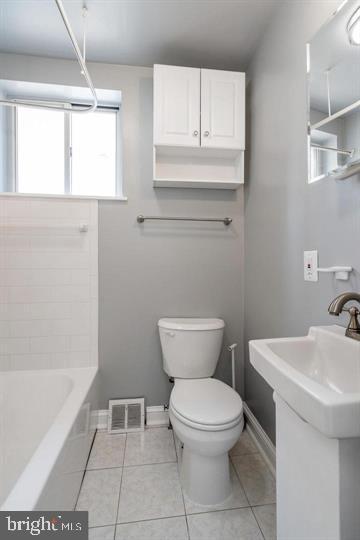 bathroom with tile patterned floors, toilet, and sink