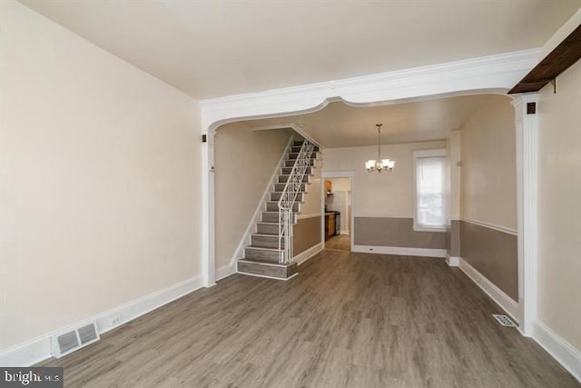 interior space featuring hardwood / wood-style flooring and a chandelier