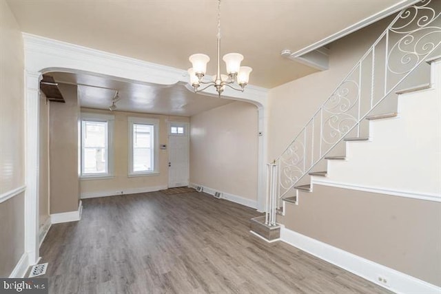 foyer with hardwood / wood-style flooring and a notable chandelier