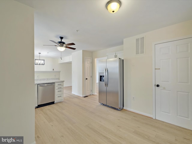 kitchen with white cabinetry, ceiling fan, stainless steel appliances, and light wood-type flooring