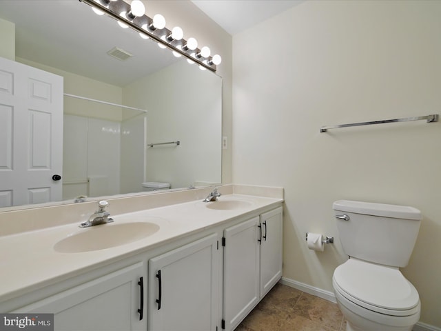 bathroom with vanity, toilet, and walk in shower