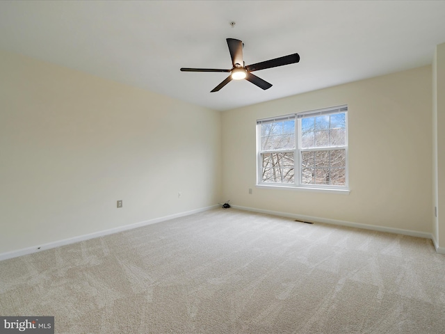 empty room with ceiling fan and light colored carpet